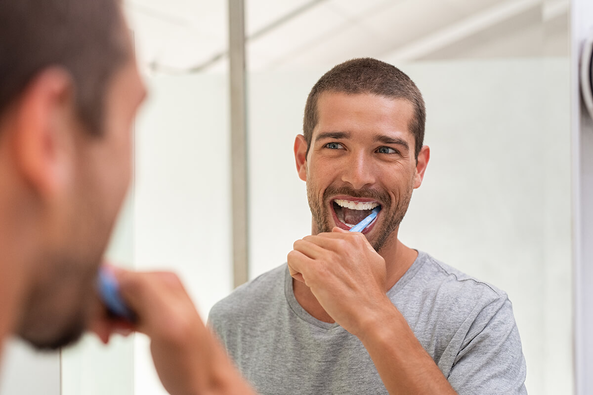 happy man brushing teeth